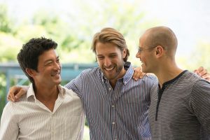 3 men smiling while engaged in a PHP for addiction rehab