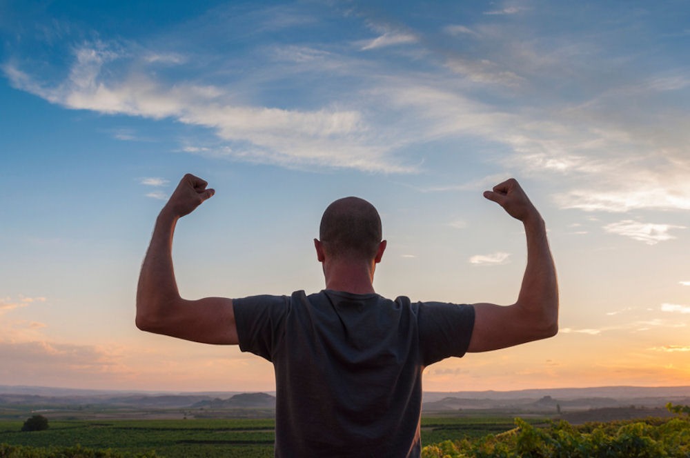 Man celebrating strength and recovery during his sober vacation journey