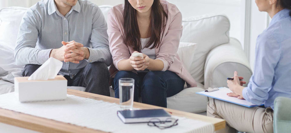 man and woman in therapy appointment for alcohol addiction treatment