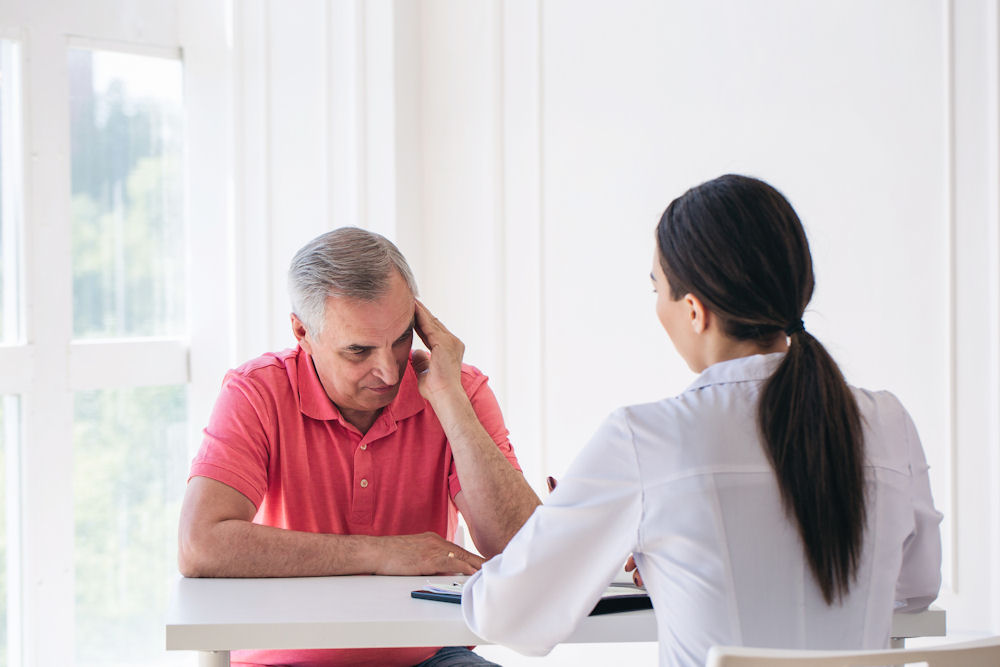 older man reviewing insurance coverage for rehab